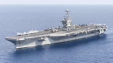 An F/A-18E fighter jet crashes from the deck of the Harry S. Truman aircraft carrier into the sea