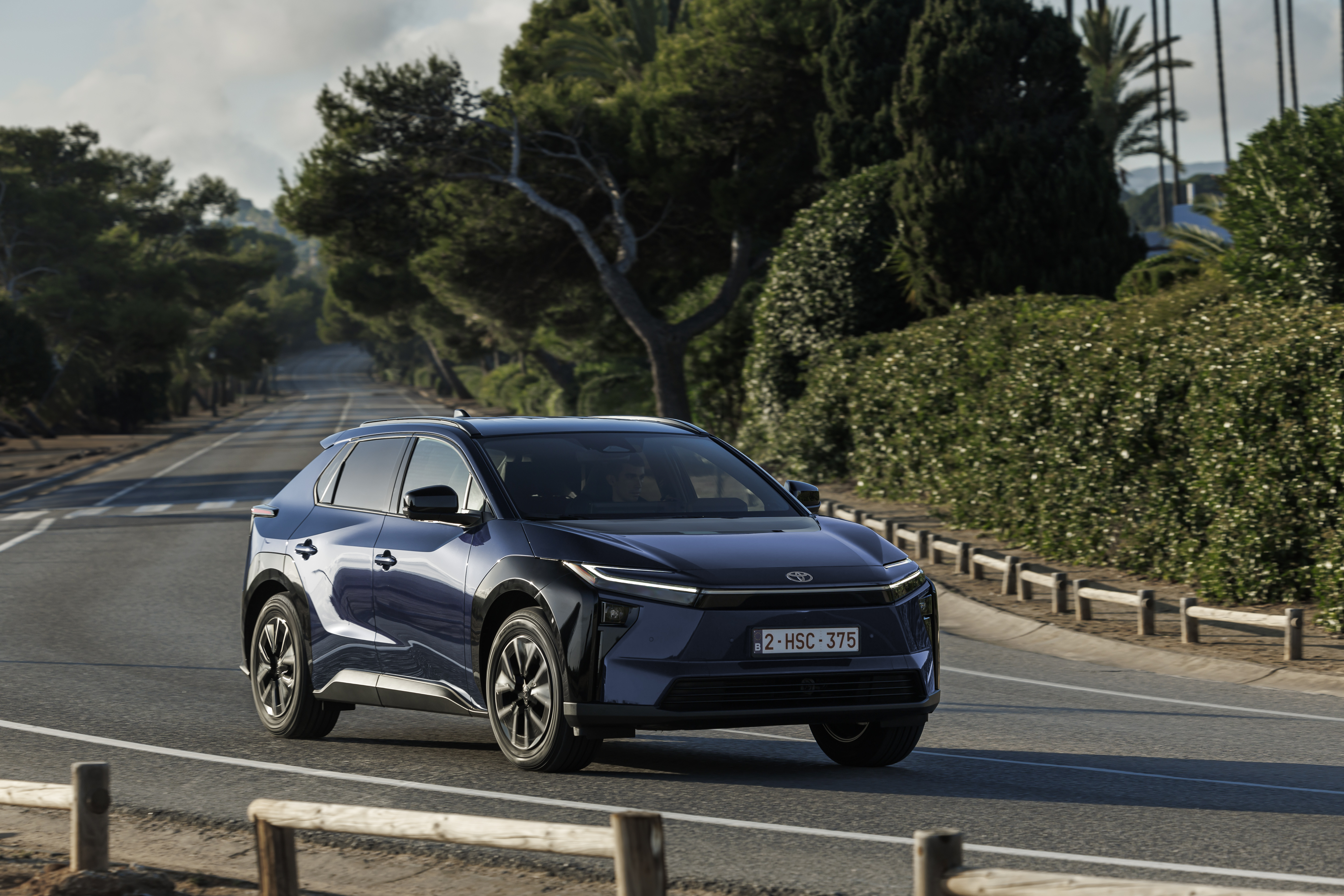 2026 Toyota bZ4X in motion, front view in deep blue metallic