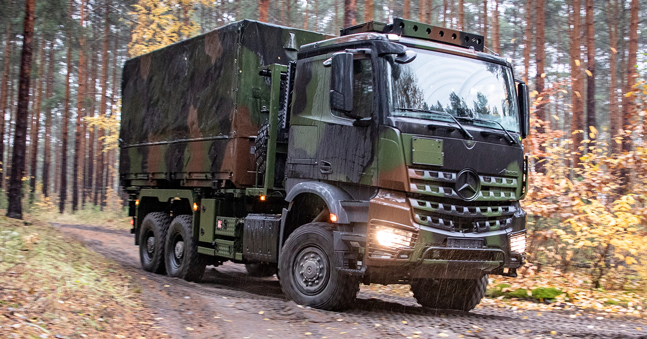Mercedes-Benz Arocs truck with military equipment.