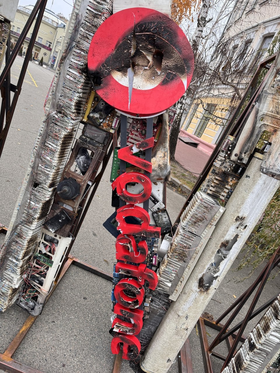 A burnt-out Vodafone sign symbolising the destruction during the war